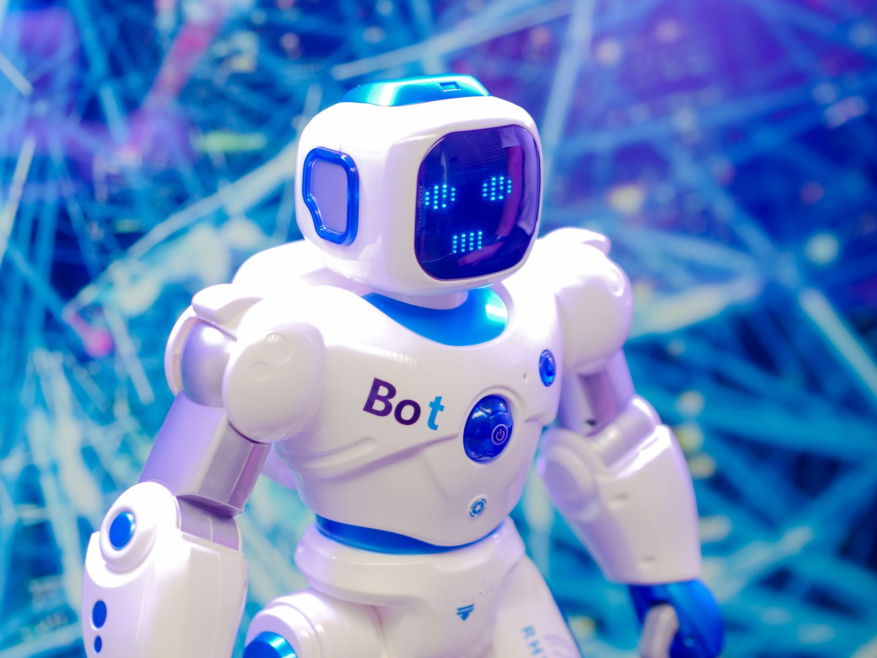An office setting where employees work at desks alongside a humanoid robot assistant