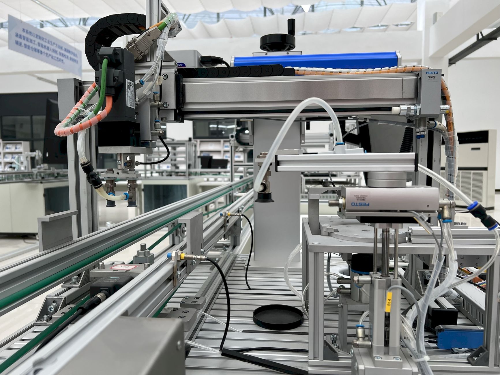 Industrial automation control room with monitors displaying factory floor sensors and robotic equipment